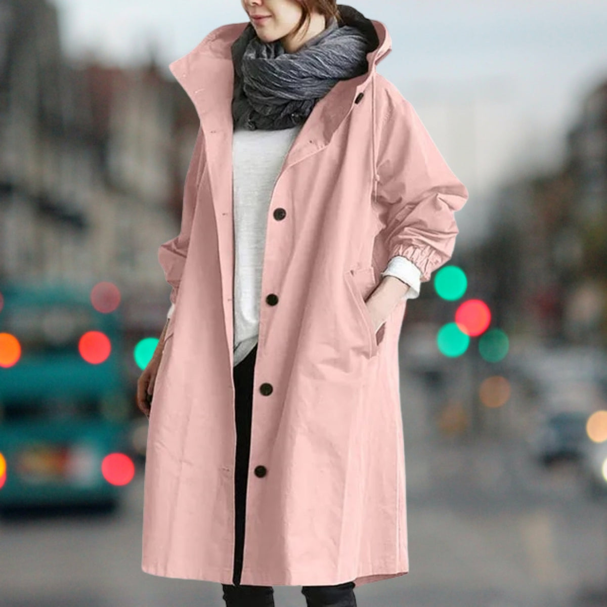 Women's longline hooded rain coat with button front and side pockets