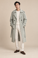 Men's green double-breasted trench coat with a waist belt and epaulettes