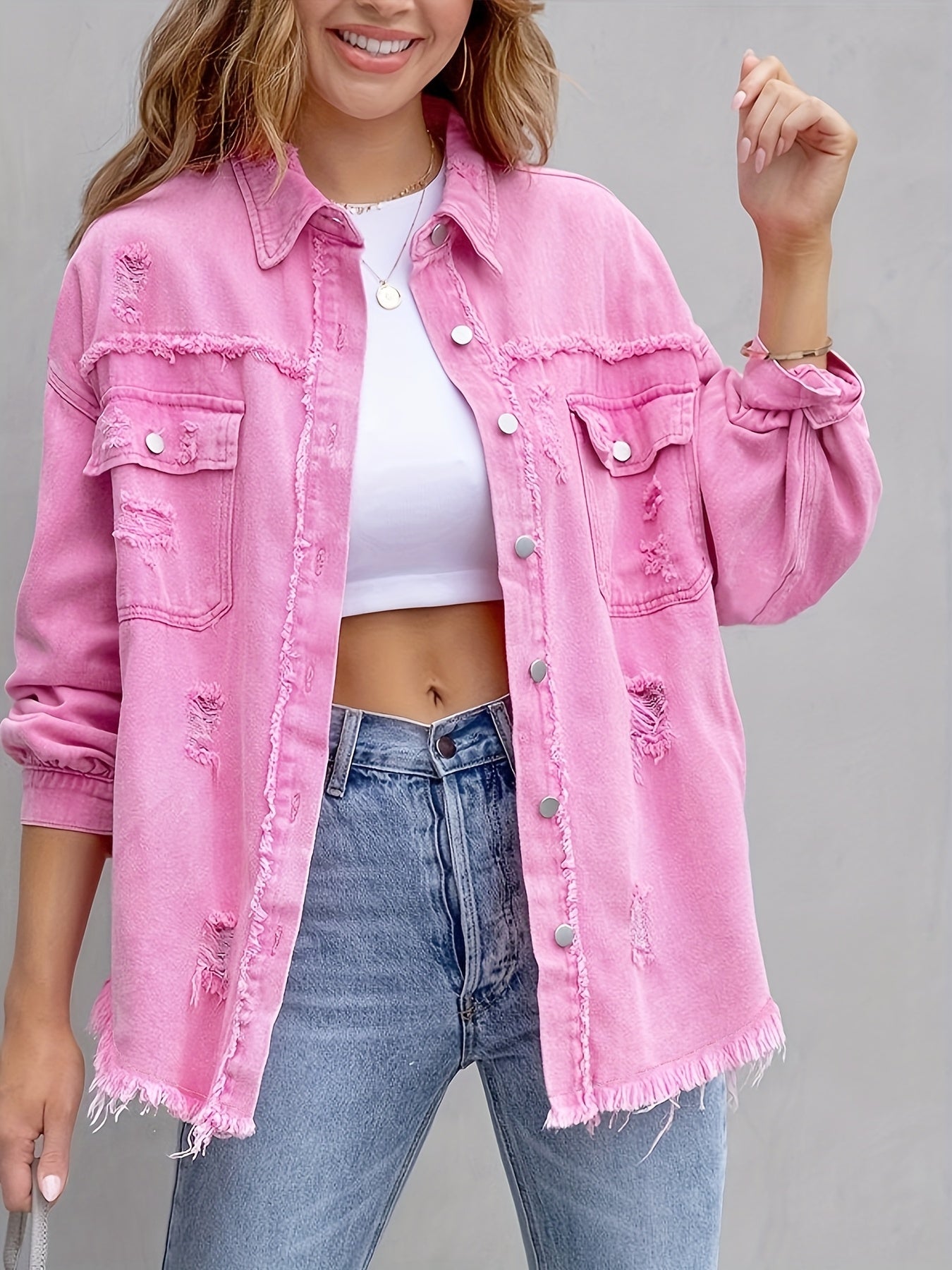 Women's pink distressed denim jacket with pockets and frayed hem