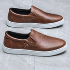 Men's slip-on loafers with rounded toes and contrasting white soles