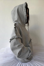 Women's grey pullover hoodie with ruffle trim around the hood and sleeves