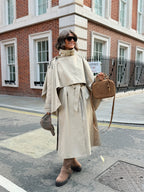 Women's beige long trench coat with high collar, buttons and tied waist belt