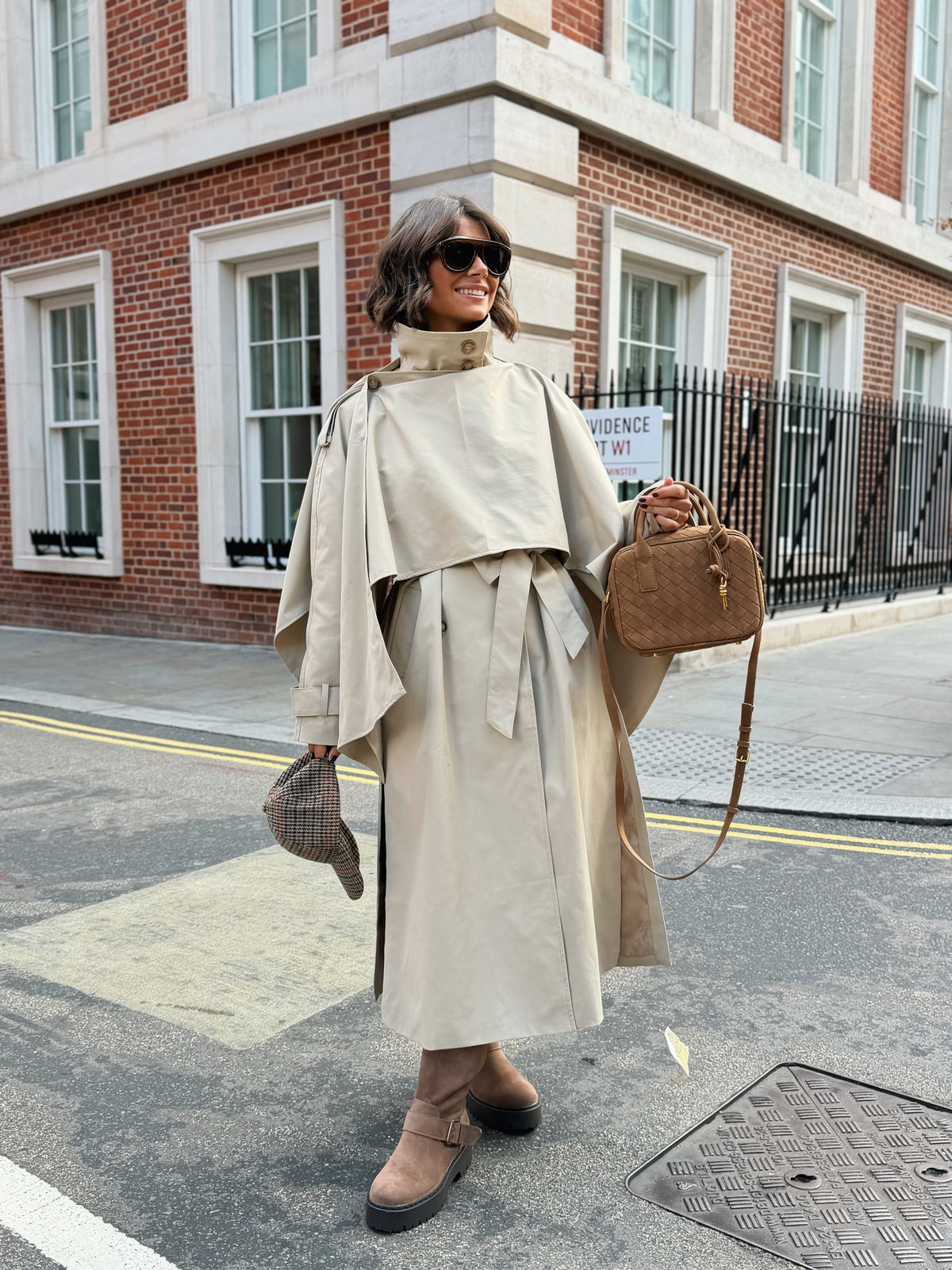 Women's beige long trench coat with high collar, buttons and tied waist belt