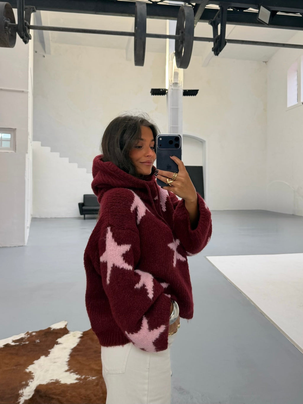Women's burgundy sweater with contrasting pink star pattern and long sleeves