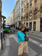 Women's blue asymmetric long sleeve top worn off one shoulder
