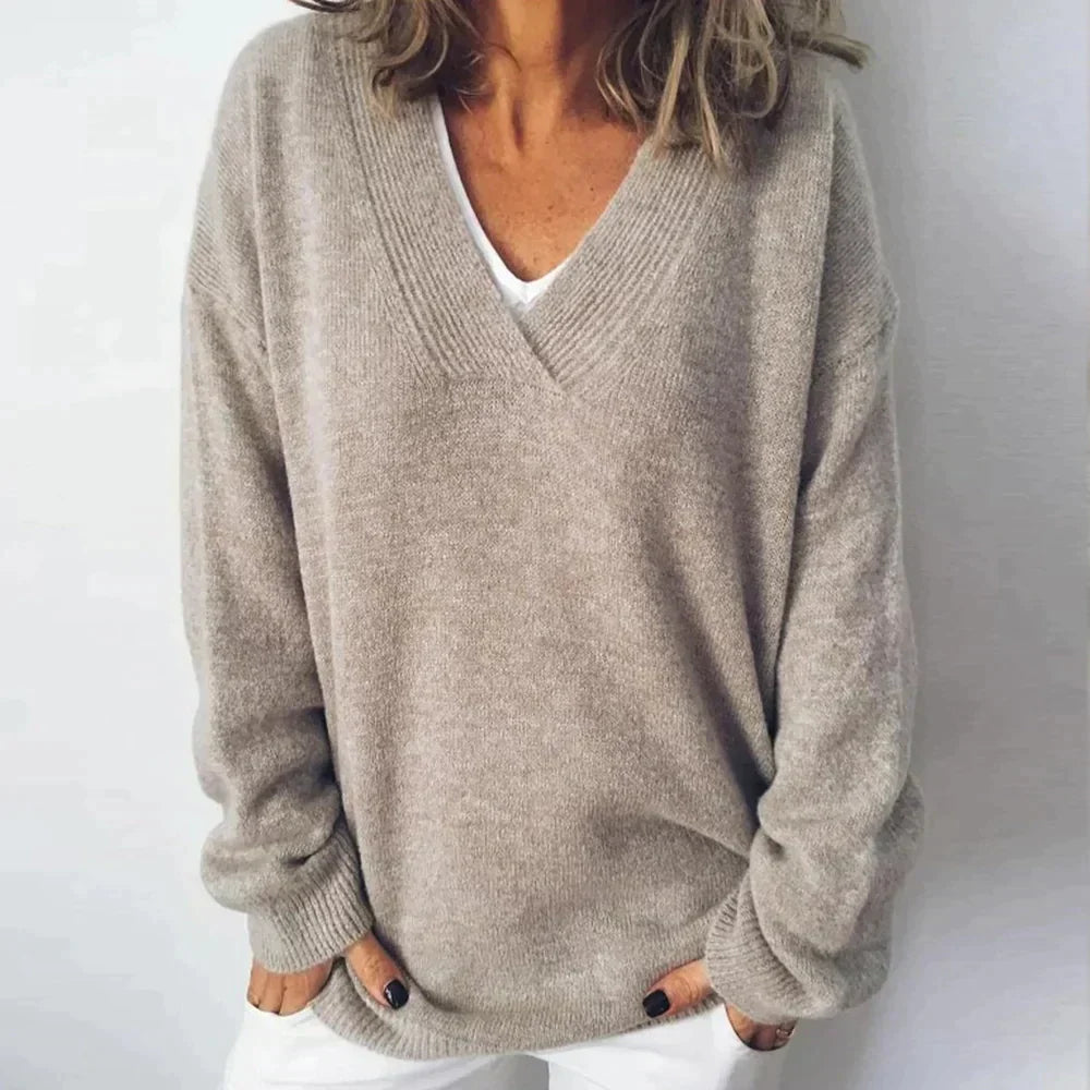 Women's relaxed knit sweater with a deep V-neck and long sleeves
