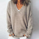 Women's relaxed knit sweater with a deep V-neck and long sleeves