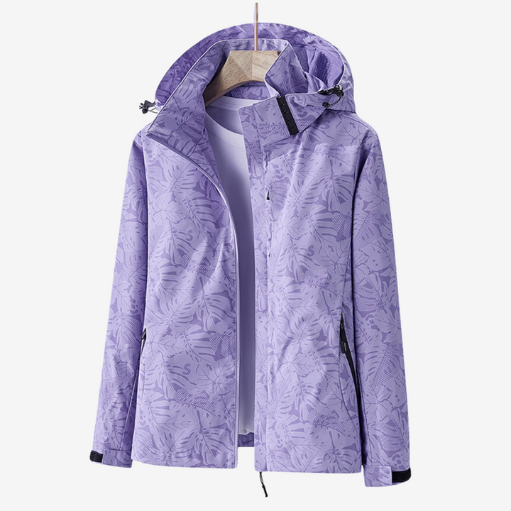 Women's hooded leaf print windbreaker jacket with long sleeves and zipped pockets