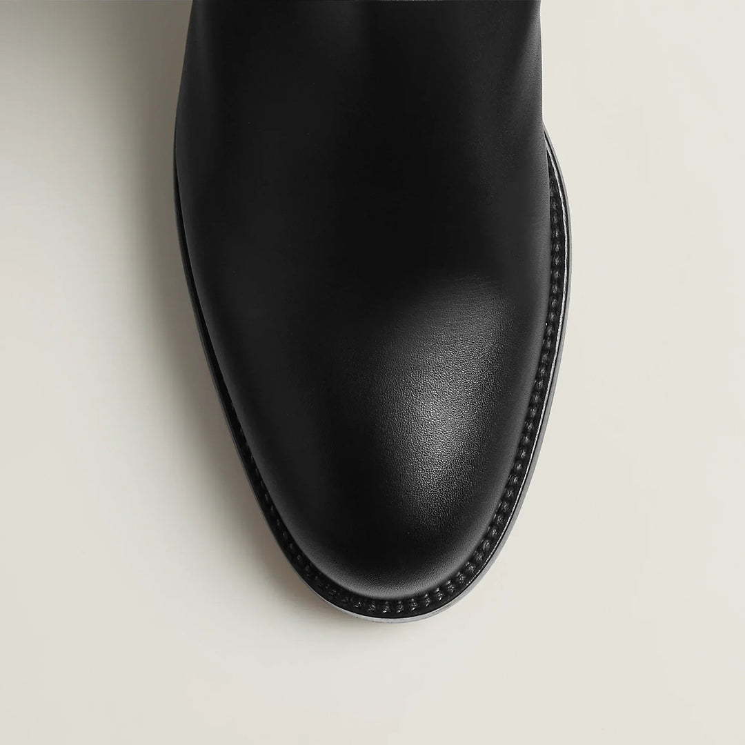 Women's tall riding boots with low heels, round toes and strap detailing