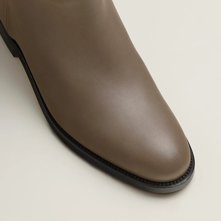 Women's tall riding boots with low heels, round toes and strap detailing