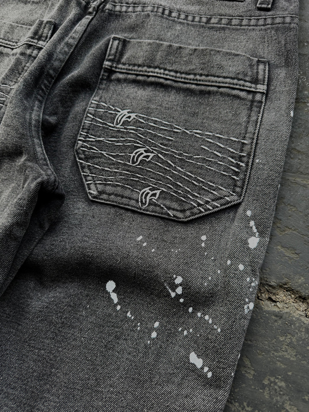 Dark washed wide leg jeans with dragon and floral embroidery