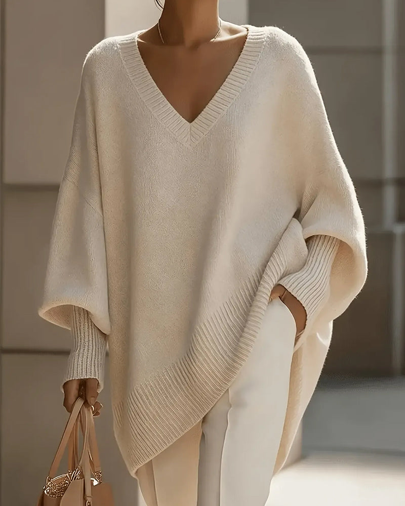 Women's oversized V-neck jumper with batwing sleeves and asymmetric hem