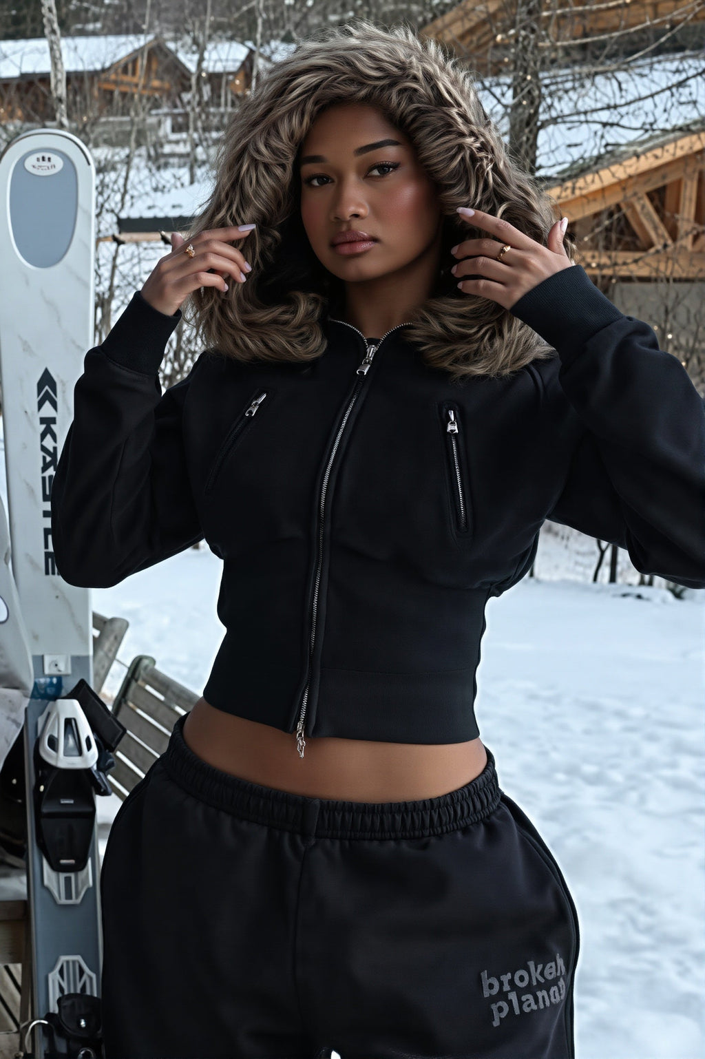 Women's black cropped zip hoodie with faux fur trimmed hood and zipped pockets