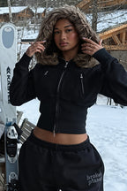 Women's black cropped zip hoodie with faux fur trimmed hood and zipped pockets