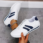 Women's white lace-up sneakers with dark side stripes