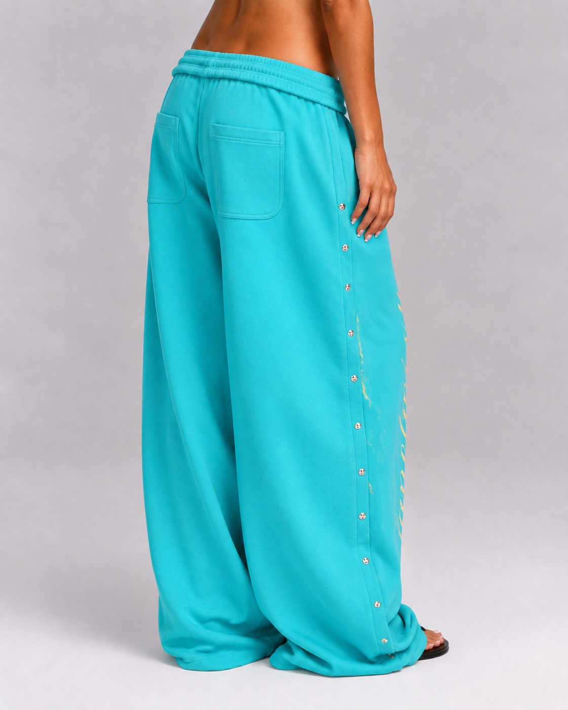 Women's turquoise wide leg jogger trousers with side snaps and drawstring waist