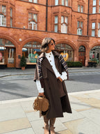 Women's brown long trench coat with wide lapels and cape-style sleeves