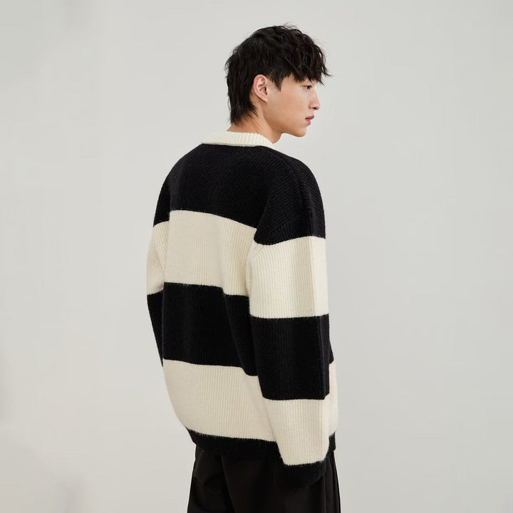 Men's black and cream striped polo sweater with long sleeves and button placket