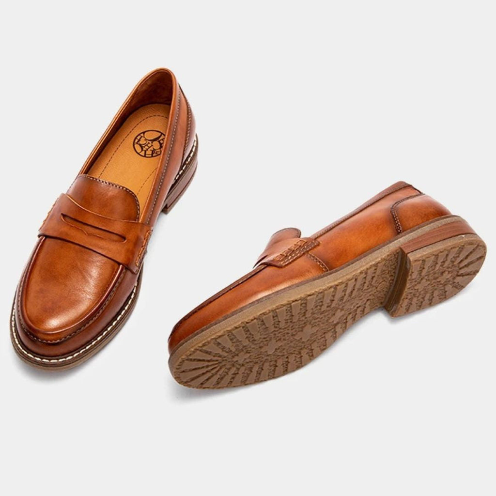 Men's penny loafers with rounded toes, stitched trim and low heels