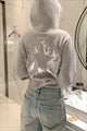 Cropped hooded pullover with long sleeves and a large sequin star design on the back
