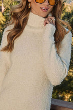 Women's cream turtleneck knit mini dress with long sleeves and tassel hem