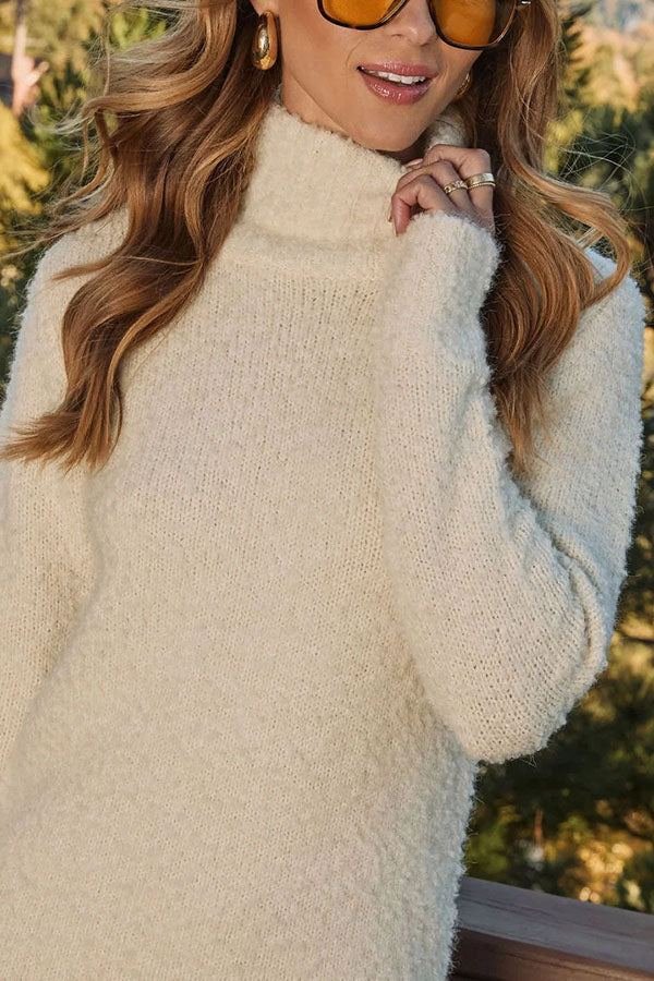 Women's cream turtleneck knit mini dress with long sleeves and tassel hem