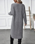 Women's long plain sweater dress with round neck, long sleeves and asymmetric hem