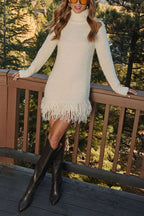 Women's cream turtleneck knit mini dress with long sleeves and tassel hem