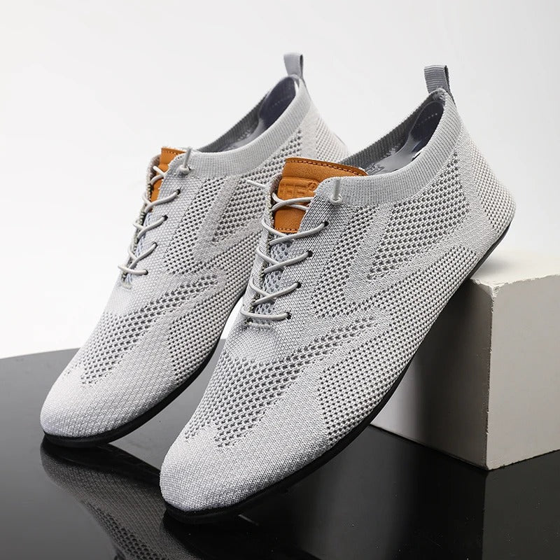 Knit sneakers with lace-up fronts, round toes and pull tabs