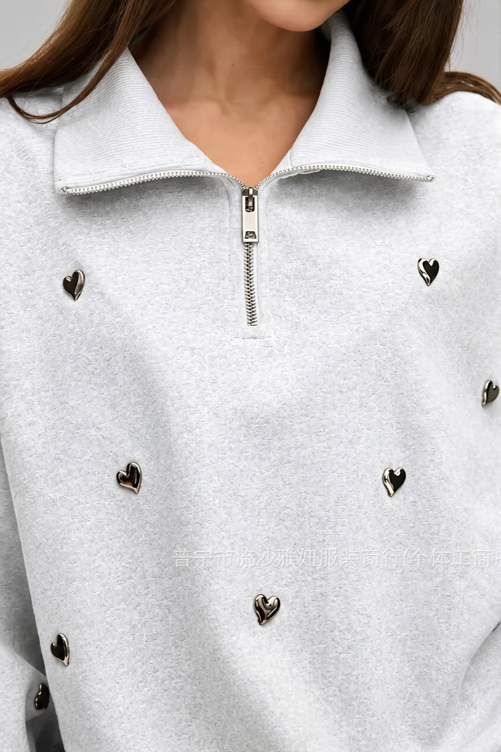 Women's light gray half-zip sweatshirt with black heart studs