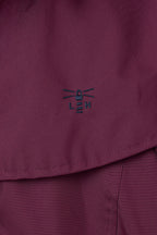 Women's hooded long raincoat with cape overlay and button front
