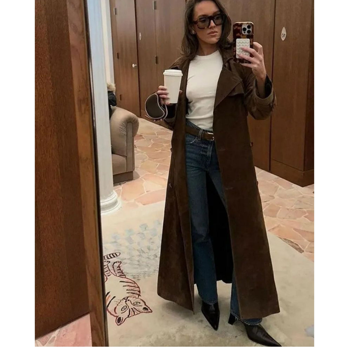 Women's long brown trench coat with lapel collar and button fastening