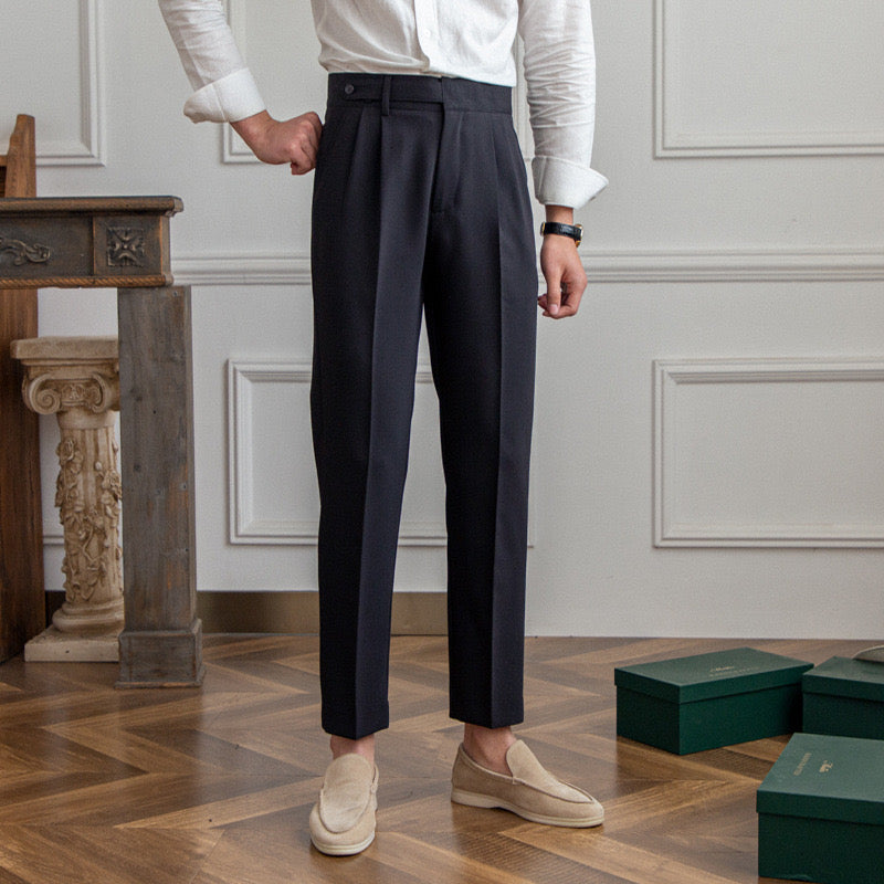 Women's high-waisted pleated straight-leg trousers shown in beige and black