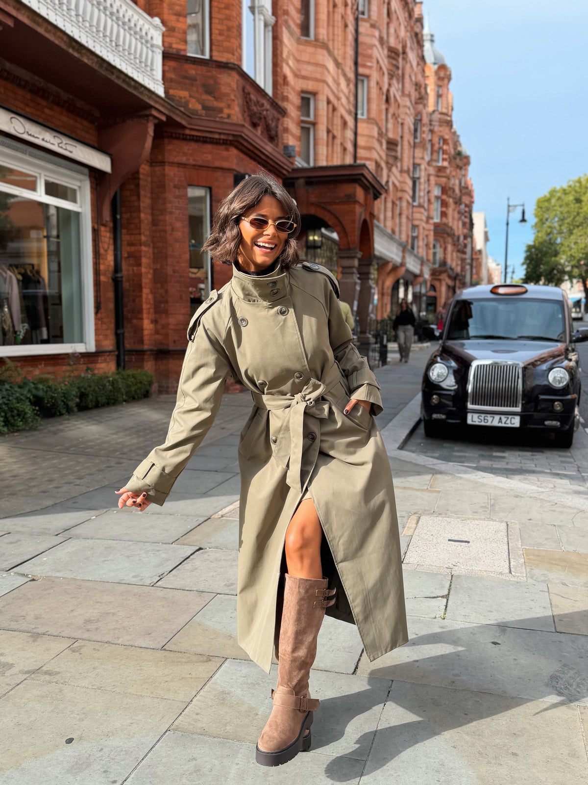 Women's beige belted trench coat with cape overlay and long sleeves