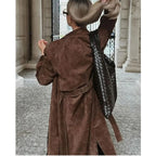 Women's long brown trench coat with lapel collar and button fastening