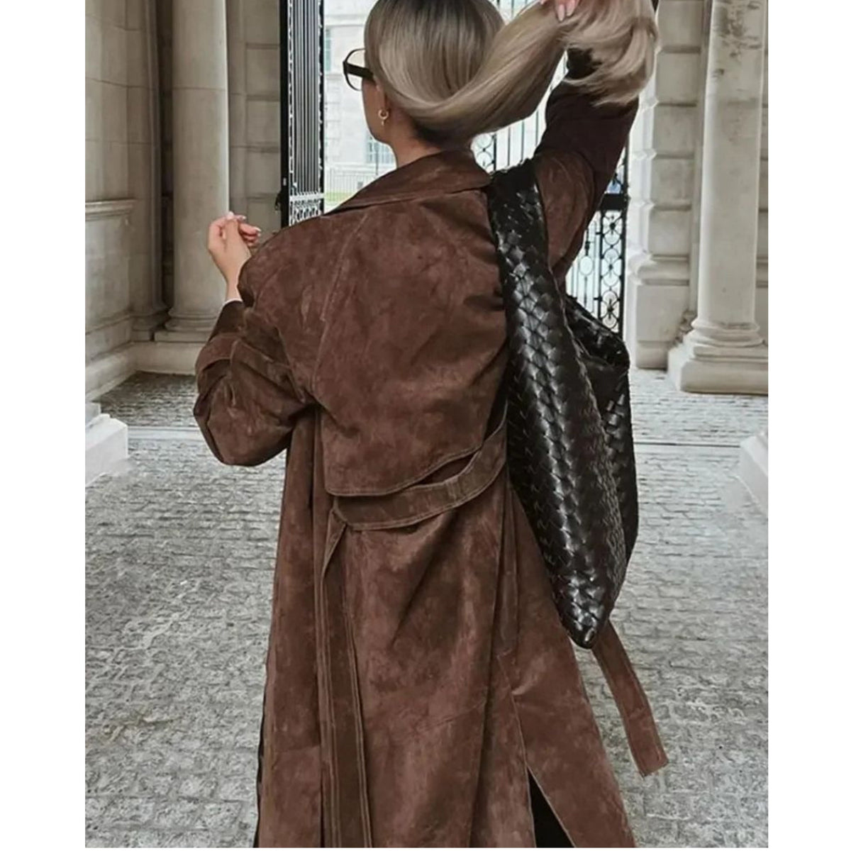 Women's long brown trench coat with lapel collar and button fastening