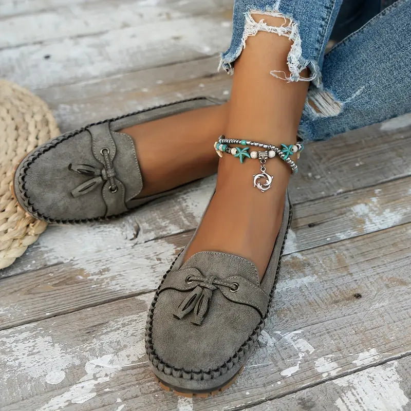 Women's flat moccasin loafers with decorative lacing and rounded toes