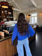 Women's royal blue V-neck sweater with long sleeves and ribbed trims