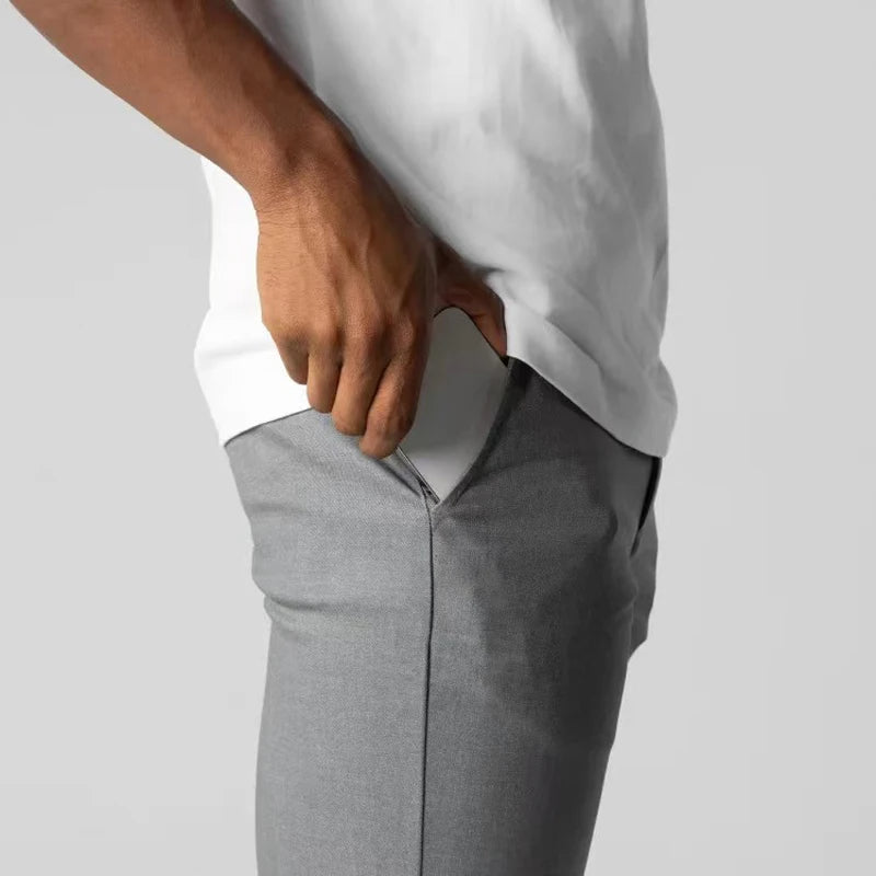 Men's slim tapered chinos trousers shown in black and navy with side pockets