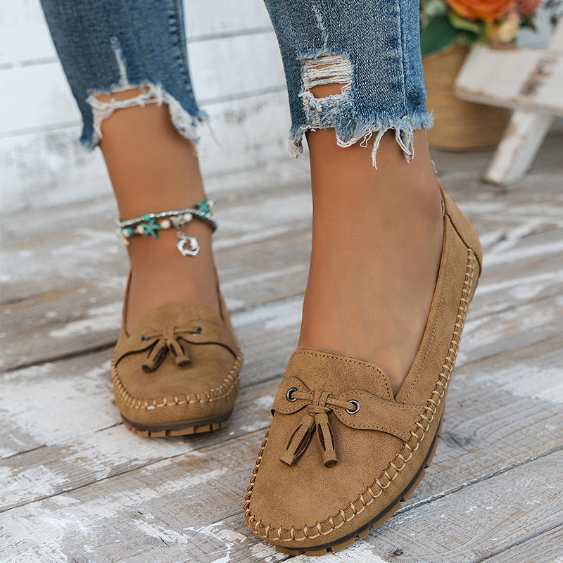 Women's flat moccasin loafers with decorative lacing and rounded toes