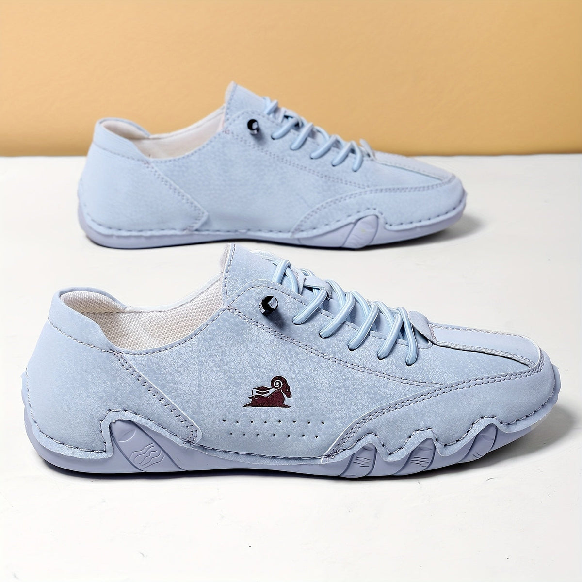 Low-profile lace-up trainers with rounded toes, stitched panels and textured soles