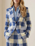 Women's blue checked blazer with notched collar, long sleeves and flap pockets