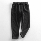 Unisex ribbed corduroy trousers with elasticated waist, side pockets and turned-up hems