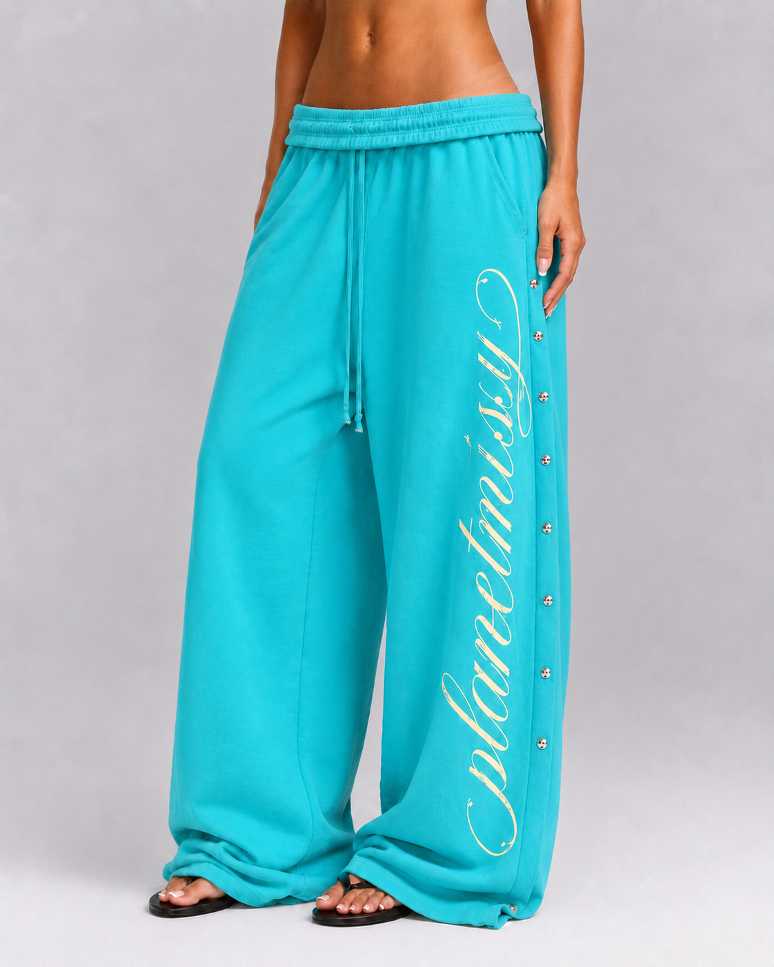Women's turquoise wide leg jogger trousers with side snaps and drawstring waist