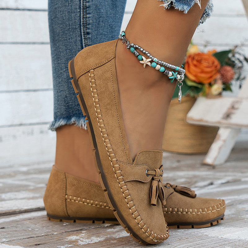 Women's flat moccasin loafers with decorative lacing and rounded toes