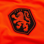 Orange men's Netherlands home football shirt with black trim and crest