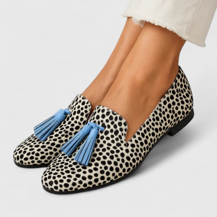 Women's black and white polka dot loafers with blue tassels
