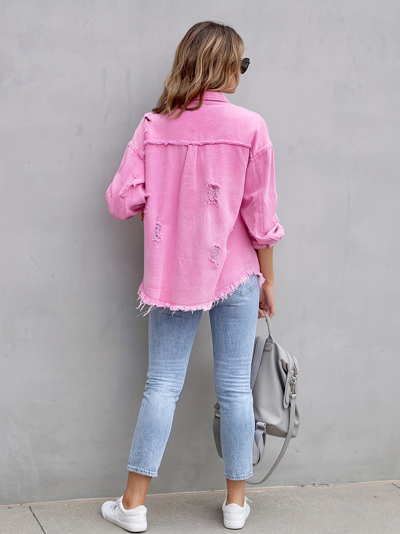 Women's pink distressed denim jacket with pockets and frayed hem