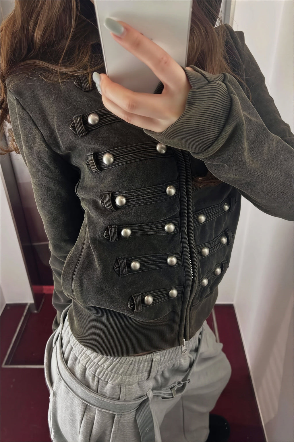 Women's black fitted hoodie with studded front trims and zip fastening