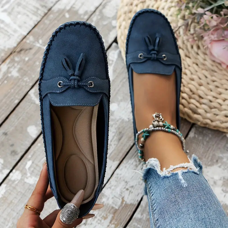 Women's flat moccasin loafers with decorative lacing and rounded toes